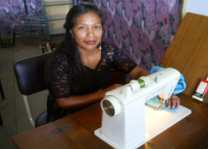 An eager sewing student in the FIDESMA sewing classroom.
