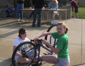 Students preparing a bicycle for the shipping container