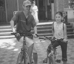 Slavic and Gabrielle with the bike she earned working in the shop