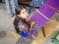Maria using the hand loom