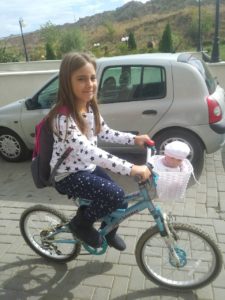 Girl riding home from school in Kosovo