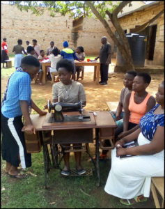 Group at treadle sewing machine