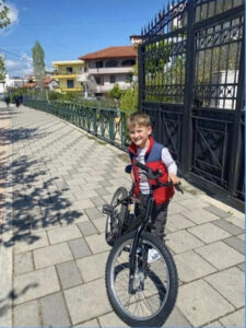 10-year-old boy with his bike in Albania