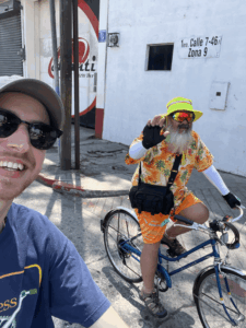 Alan and guy in costume on bikes, Guatemala 2025