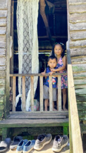 Belize, June 2025: boy and girl on porch
