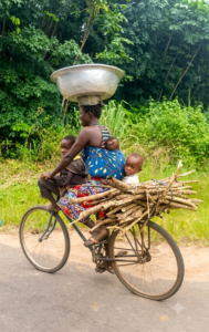 Togo woman on bike with cargo and kids